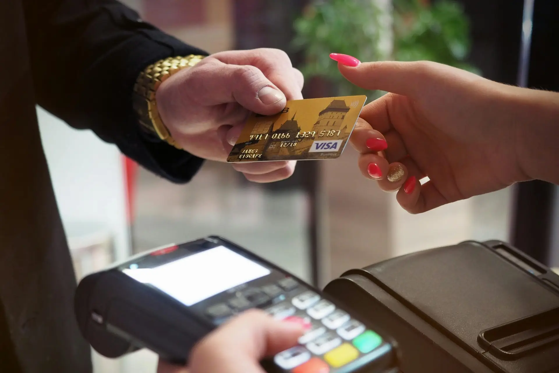 Close-up of a credit card payment being processed at a POS terminal.