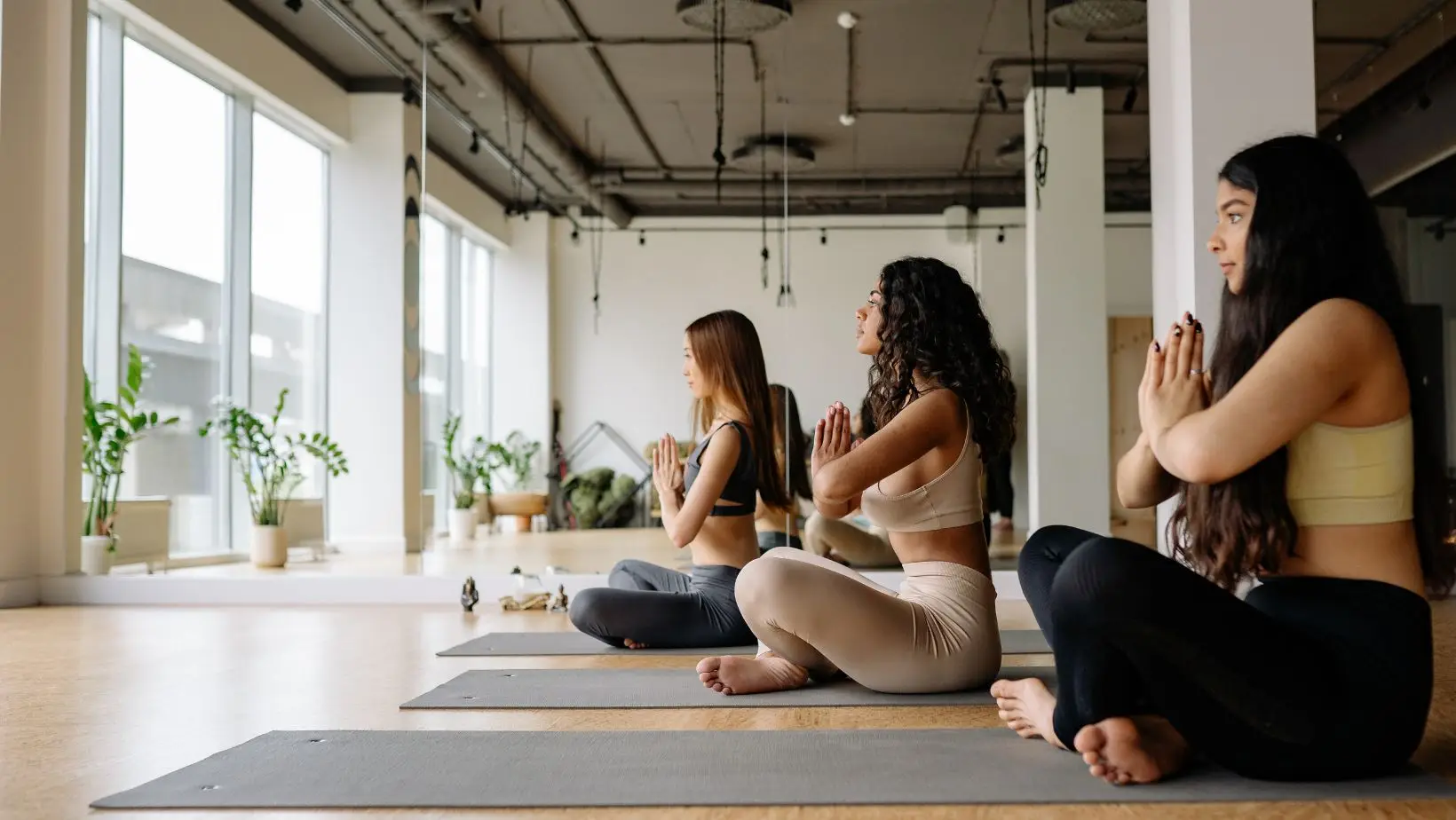 Women practicing yoga in studio.